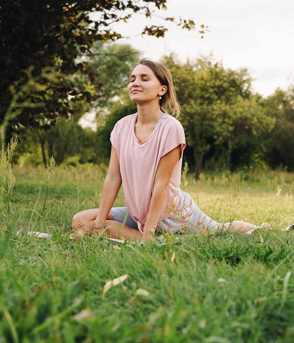 Woman in a relaxed pose breathing deeply in a calm environment.